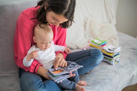 Babsit lapsit storytime. Mother reading to child on her lap.
