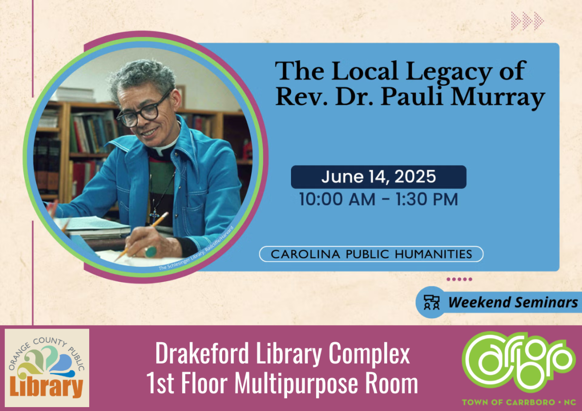 Photo of Pauli Murray in a blue shirt writing at a desk
